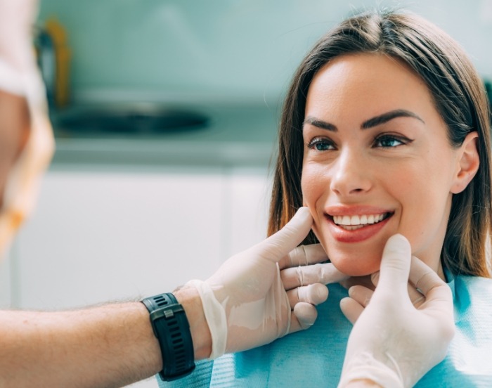 Woman smiling at her dentist right after a treatment