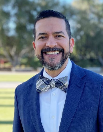 Naples prosthodontist Doctor Randold Binns smiling in a suit