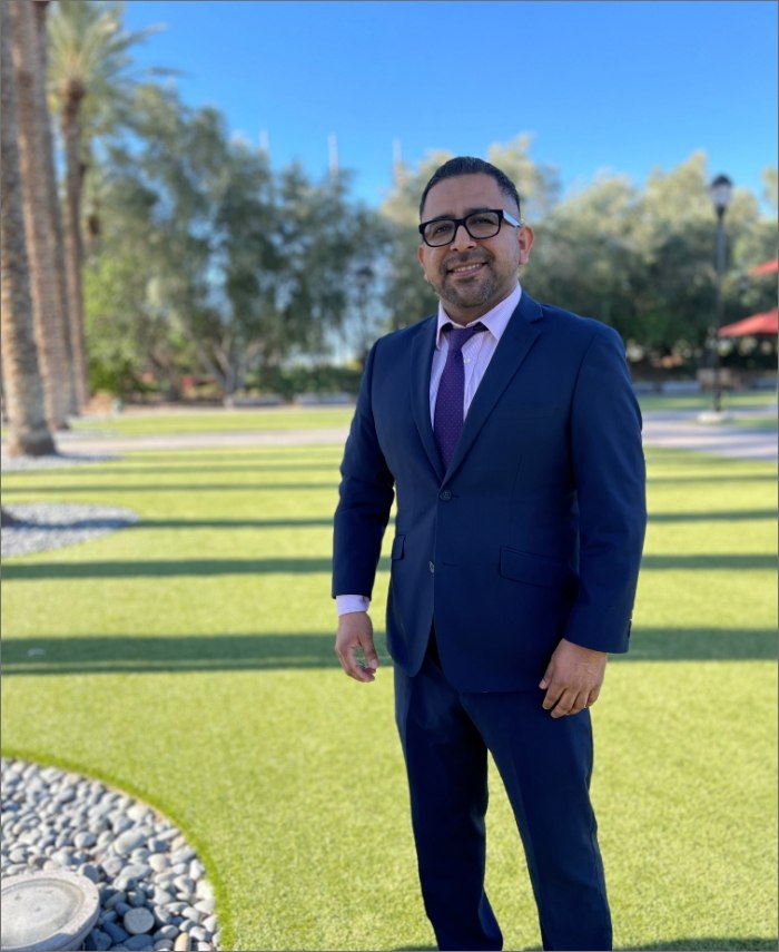 Naples maxillofacial prosthodontist Doctor Eugenio Aquino smiling outdoors in a suit