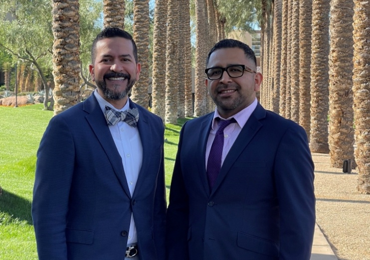 Two Naples dentists smiling outdoors in suits